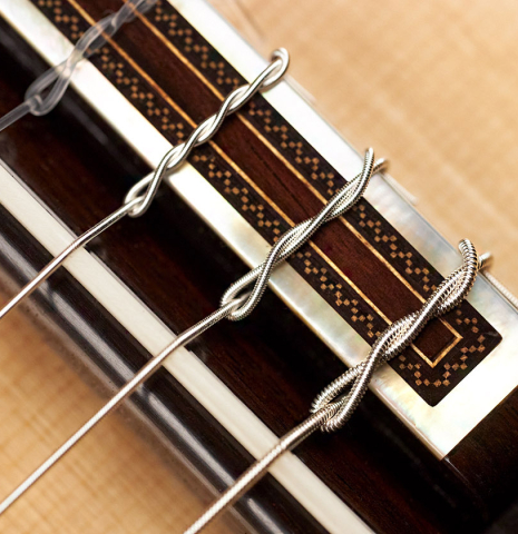 The bridge and saddle of a 2023 Luigi Locatto classical guitar made of spruce and CSA rosewood