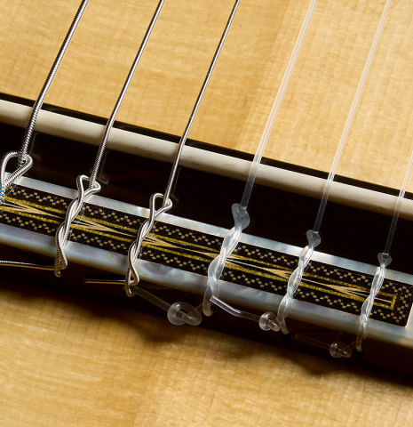 The bridge, tie-block and saddle of a 2026 Luigi Locatto classical guitar made of spruce and CSA rosewood