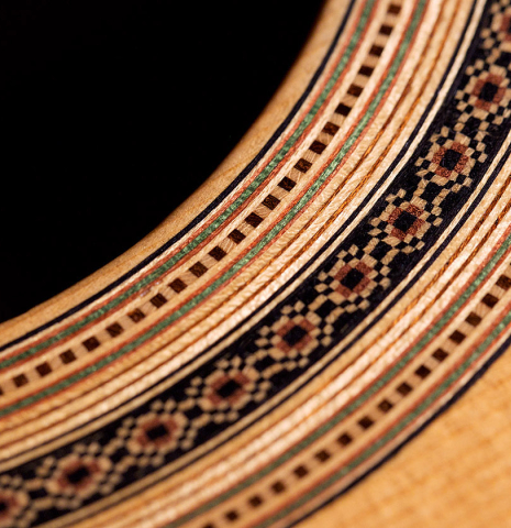 The rosette of a 2006 Luigi Locatto classical guitar made of spruce and Indian rosewood