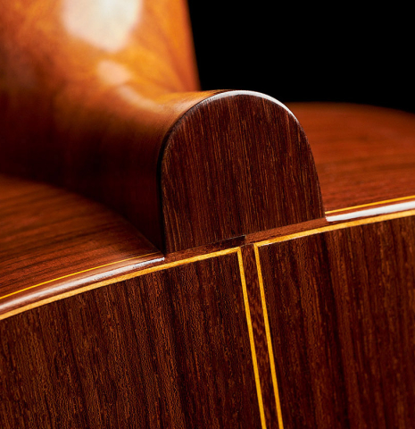 The heel, back binding and purfling of a 2019 Luigi Locatto classical guitar made of spruce and Indian rosewood