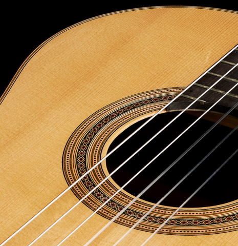 The top and rosette detail of a 2006 Luigi Locatto classical guitar made with spruce and Indian rosewood