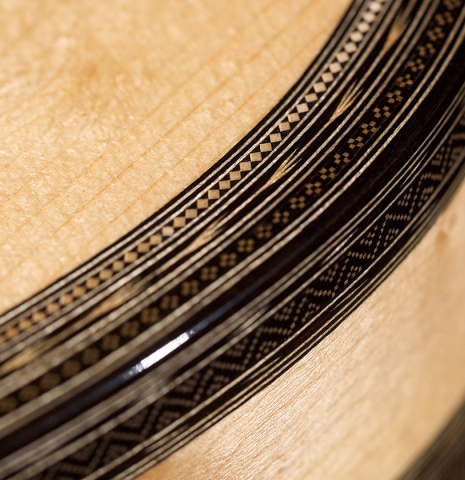 A close-up of the binding and purfling of a 2021 Gabriele Lodi &quot;Torres&quot; classical guitar made of spruce and maple.