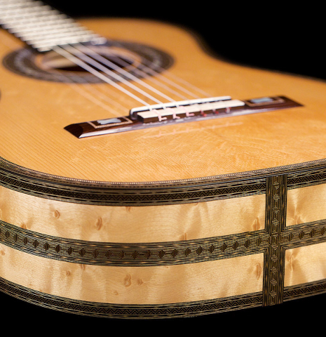 The lower bout of a 2021 Gabriele Lodi "Torres" classical guitar made of spruce and maple.