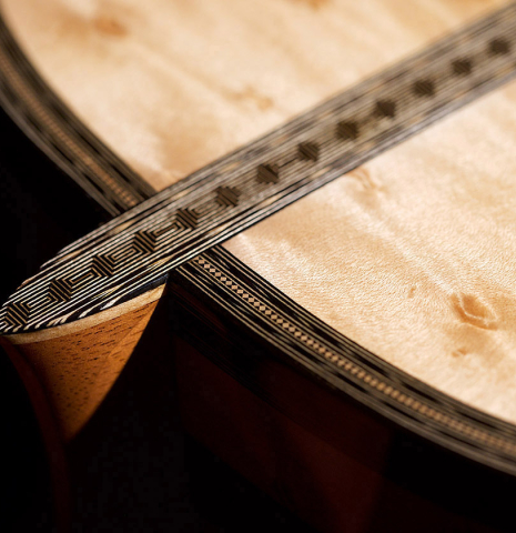 The heel of a 2021 Gabriele Lodi "Torres" classical guitar made of spruce and maple.