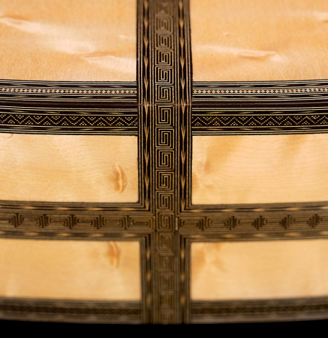 The lower bout of a 2021 Gabriele Lodi "Torres" classical guitar made of spruce and maple.