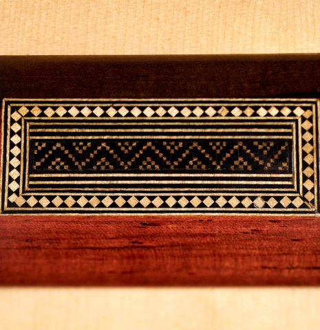 The bridge ornament of a 2022 Gabriele Lodi &quot;Torres&quot; classical guitar made of spruce and mahogany