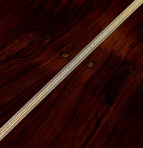 The back center seam of a 2025 Gabriele Lodi "Torres" classical guitar made of spruce and CSA rosewood