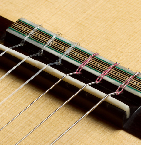 The bridge, tie-block and saddle of a 2025 Gabriele Lodi "Torres" classical guitar made of spruce and CSA rosewood