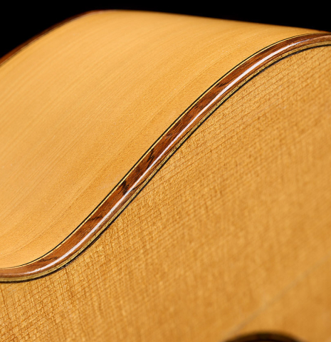 The top binding and purflings of a 1965 Marcelino Lopez classical guitar made of spruce and cypress