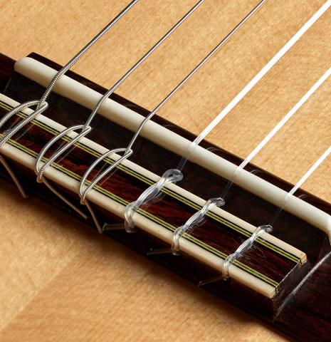 The bridge, tie-block and saddle of a Loriente "Isabel" classical guitar made pf spruce and pau ferro