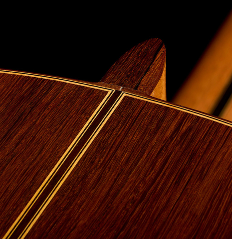 The heel, back binding and purfling of a 2009 Casimiro Lozano classical guitar made of spruce and African rosewood