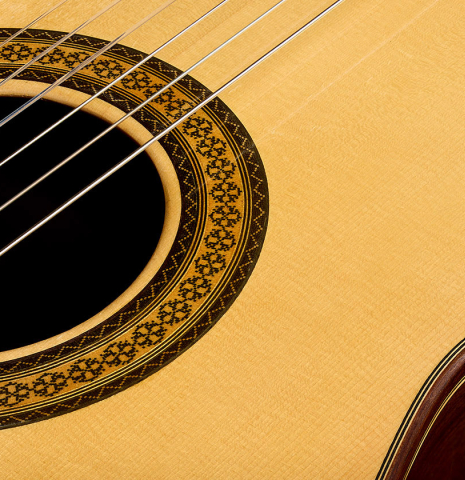 The soundboard and rosette detail of a 2009 Casimiro Lozano classical guitar made of spruce and African rosewood