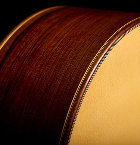 The top binding and side of a 2009 Casimiro Lozano classical guitar made of spruce and African rosewood