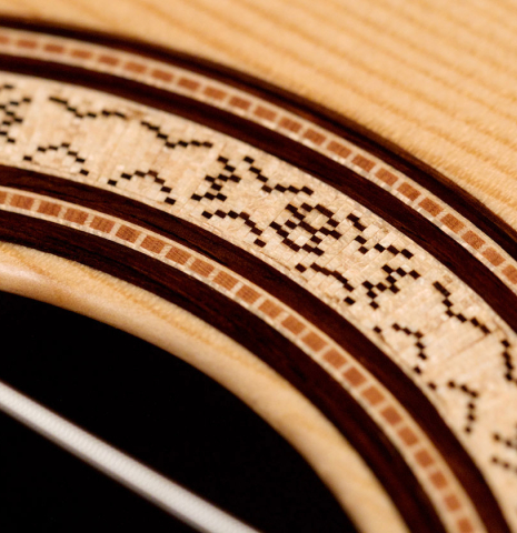 A close-up of the rosette of a 2021 Lucas Martin classical guitar made with spruce and Indian rosewood