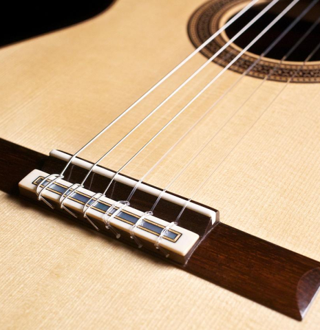 The bridge, tie-block and saddle of a 2012 Bernd Martin classical guitar made of spruce and CSA rosewood