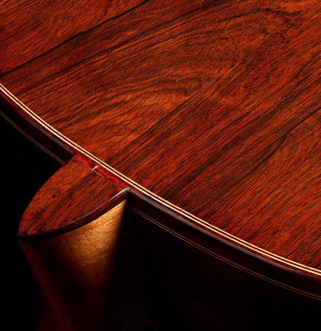 The heel and back binding of a 2013 Andres Marvi classical guitar made of cedar and CSA rosewood