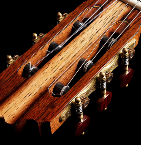 The headstock veneer and tuning machines of a 2013 Andres Marvi classical guitar made of cedar and CSA rosewood