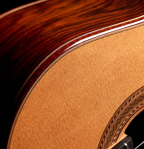 The soundboard and side of a 2013 Andres Marvi classical guitar made of cedar and CSA rosewood