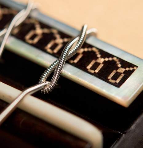 Ornamented bridge of a 2022 Daniele Marrabello guitar