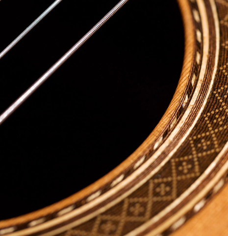 The soundboard and rosette of a 1994 Paco Santiago Marin classical guitar made of cedar and Indian rosewood