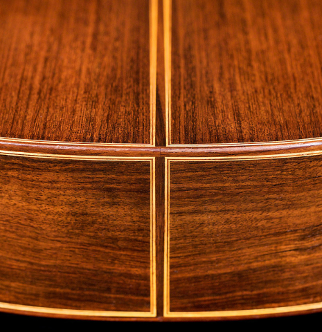 The back and sides at the foot of a 1994 Paco Santiago Marin classical guitar made of cedar and Indian rosewood