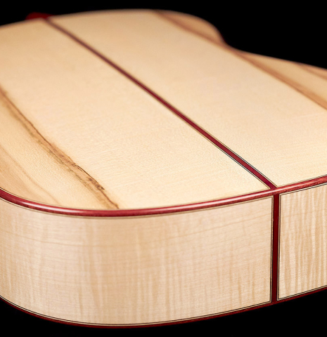 The back and sides at the foot of a 2023 Lucas Martin #100 classical guitar made with spruce top and maple back and sides.
