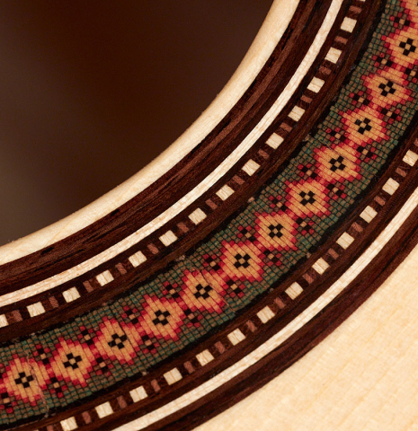 Closeup detail of the rosette of a 2023 Lucas Martin #100 classical guitar made with spruce top and maple back and sides.