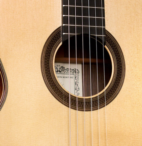 The soundboard and rosette of a 2021 Antonio Marin Montero classical guitar made of spruce and Indian rosewood