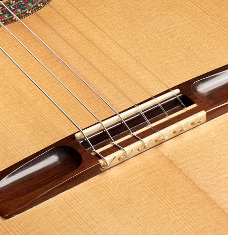 The bridge of a 2004 Simon Marty classical guitar made with spruce and CSA rosewood.