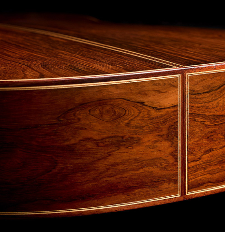 The back and sides at the foot of a 2001 Paco Santiago Marin classical guitar made of spruce and CSA rosewood