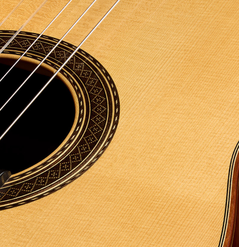 The soundboard and rosette of a 2001 Paco Santiago Marin classical guitar made of spruce and CSA rosewood