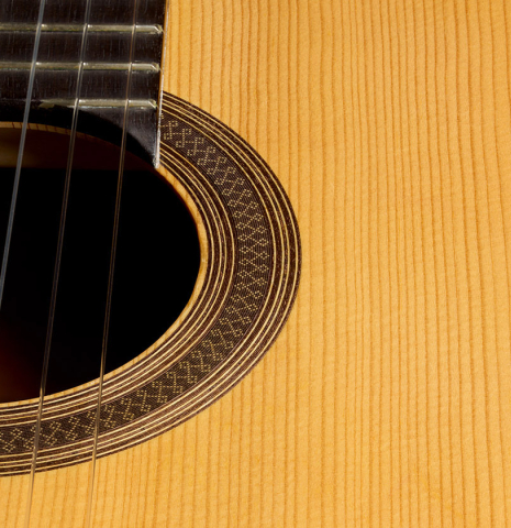 The soundboard and rosette of a 2004 Antonio Marin Montero classical guitar made of spruce and CSA rosewood