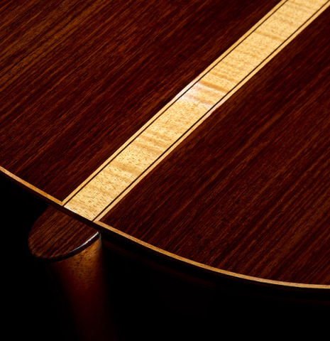 The heel, back binding and purfling of a 2021 Paco Santiago Marin "50th Anniversary" classical guitar made of spruce and Indian rosewood