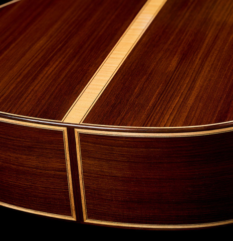 The back and sides at the foot of a 2021 Paco Santiago Marin "50th Anniversary" classical guitar made of spruce and Indian rosewood