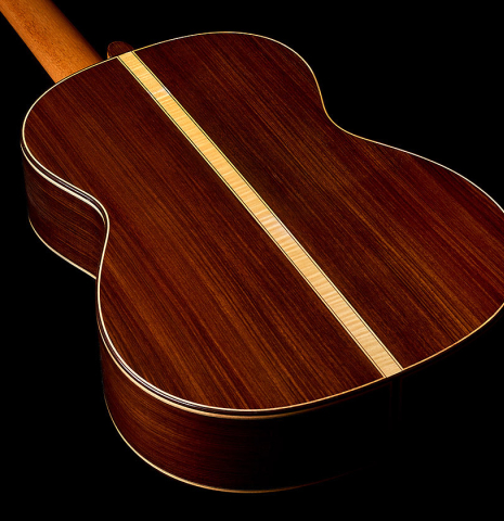 The back, sides and maple center strip of a 2021 Paco Santiago Marin "50th Anniversary" classical guitar made of spruce and Indian rosewood