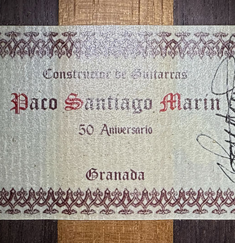 The label of a 2021 Paco Santiago Marin "50th Anniversary" classical guitar made of spruce and Indian rosewood