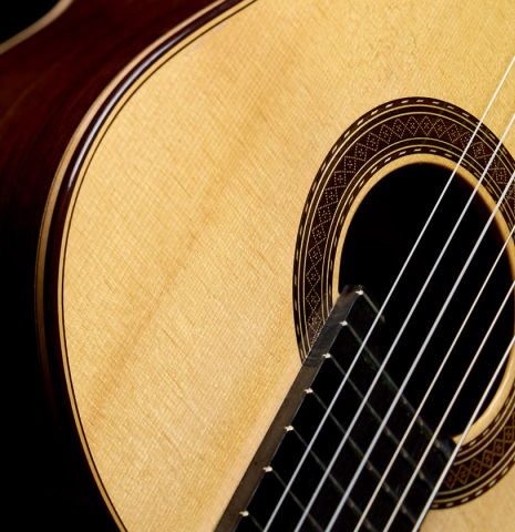 The soundboard of a 2021 Paco Santiago Marin "50th Anniversary" classical guitar made of spruce and Indian rosewood