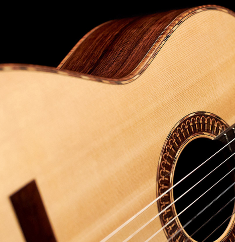 The soundboard of a 2021 Claudio Meneghelli  "Hommage to Jose Romanillos" classical guitar made with spruce and Indian rosewood