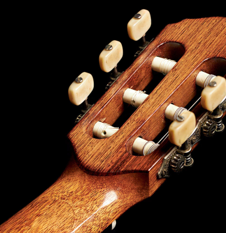 The headstock and machine heads of a 1953 Edgar Monch classical guitar made with spruce and Indian rosewood.