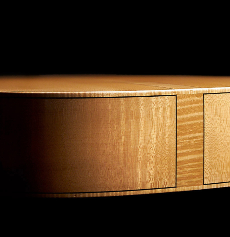 The sides at the foot of a 2011 Rafael Moreno Rodriguez classical guitar made of spruce and maple