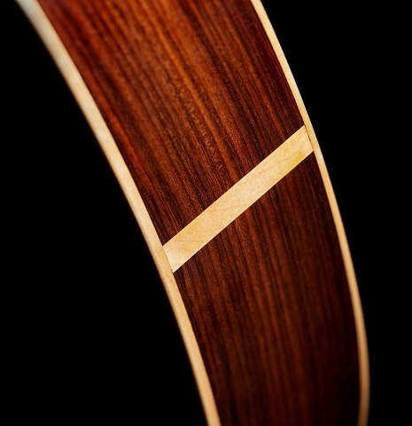 The sides at the foot of a 2017 Fernando Moreno classical guitar made of cedar and Indian rosewood