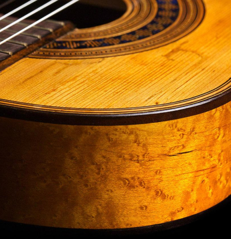 The birdeye maple side of a The rosette of a 1894 Hijos de Melchor de Moya guitar made of spruce