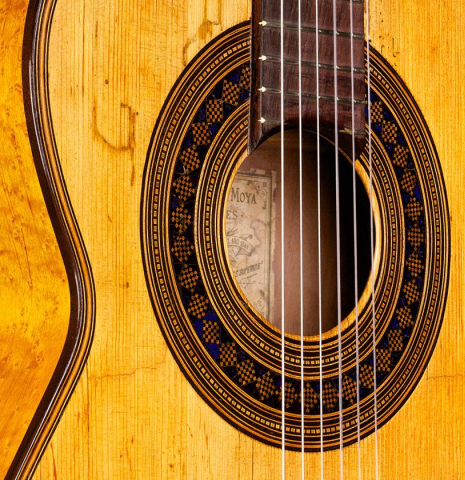 The front and side of a 1894 Hijos de Melchor de Moya guitar made of spruce and maple
