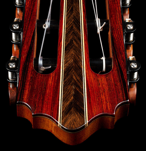 The headstock veneer of a 2025 Oscar Munoz classical guitar made of cedar and African rosewood