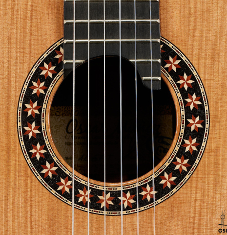 The rosette of a 2025 Oscar Munoz classical guitar made of cedar and African rosewood