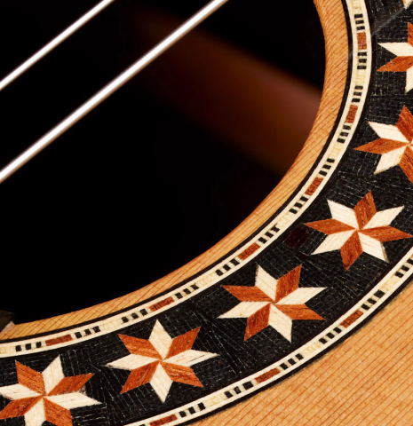 Closeup detail of the rosette of a 2025 Oscar Munoz classical guitar made of cedar and African rosewood