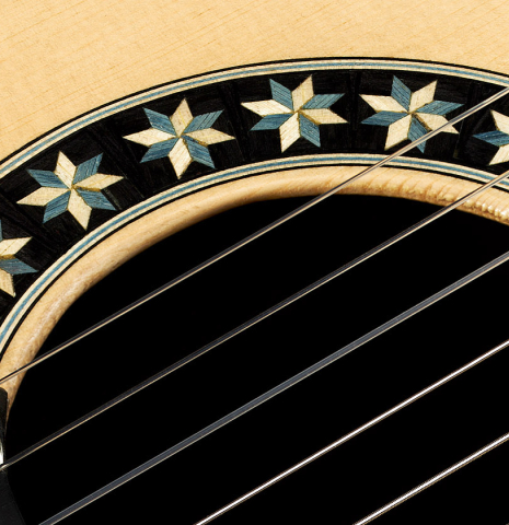 Detailed closeup of the rosette of a 2024 Oscar Munoz classical guitar made of spruce and Makassar ebony