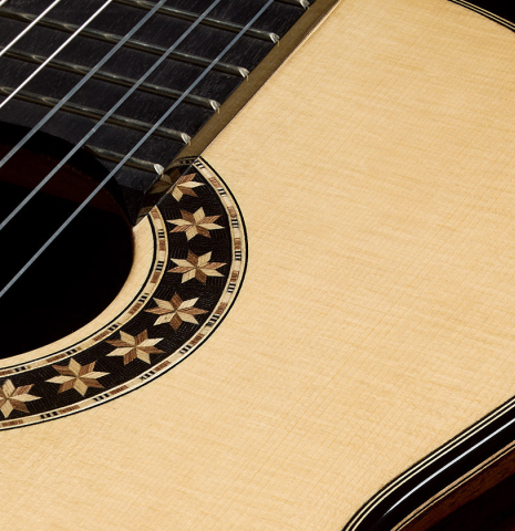 The soundboard and rosette detail of a 2026 Oscar Munoz classical guitar made of spruce and Makassar ebony