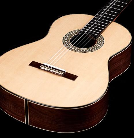 The soundboard of a 2022 Miguel Angel Gutierrez classical guitar made of spruce and Indian rosewood.