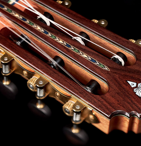 The headstock of a 2022 Miguel Angel Gutierrez classical guitar made of spruce and Indian rosewood.